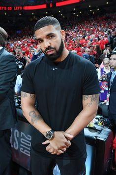 a man standing in front of a crowd at a basketball game