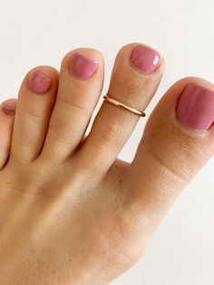 A simple handcrafted toe ring band in 2mm width is super comfortable and looks great stacked with other toe rings. Available in sterling silver, gold fill or 14k yellow gold. Available in fitted sizes 1 - 6 1/2. Also makes a great finger or midi ring. If you don't know your ring size, download this ring sizing chart from wikiHow: http://www.wikihow.com/Find-Your-Ring-Size We also offer a Multi-Sizer sizing belt for $2.99. https://www.etsy.com/listing/288821125/multisizer-ring-sizing-belt-reusabl Pie, Couple Ring Finger Tattoos, Ring Tattoo Designs, Fashion Jewelry Necklaces Gold, Aesthetic Jewellery, Toe Ring Designs, Gold Toe Rings, Jewellery Aesthetic, Ring Finger Nails