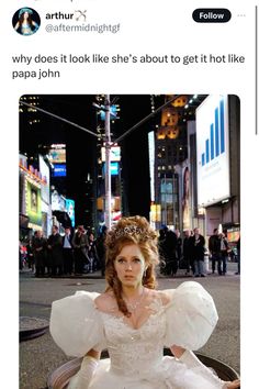 a woman in a white dress sitting on the ground