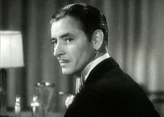 black and white photograph of a man in a tuxedo looking off to the side