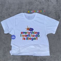 This colorful clowncore shirt was inspired by kidcore shirt and clowncore clothing. This funny tee is the perfect funny meme shirt to wear for when you just want to confuse everyone with what you meant by saying Everything I Want To Do Is Illegal. Totally not an inspirational shirt - nor a motivational one. But this shirts will surely be a funny gift for her, funny gift for him or anyone in between as these funny tshirts are unisex. Available in XS, S, M, L, XL, 2XL, & 3XL ✨ 100% ⭐️ PREMIUM ⭐️ Airlume combed and ringspun cotton  ✨ Light fabric ✨ Retail Unisex fit ✨ Tear away label ✨ Runs true to size ✨ Original MilkDesigns ‼️ Print Size will scale up or down depending on the shirt size to keep the integrity of the print. *Sustainability Commitment: All of our products are made only upon pu Cursed Tee Shirts, Gaycore Outfits, Silly Shirt Designs, Masc Clowncore, School Dance Outfits Masc, Funky Tshirts Designs, Gore Clothes, Silly T Shirts, Nonbinary Fashion Outfits