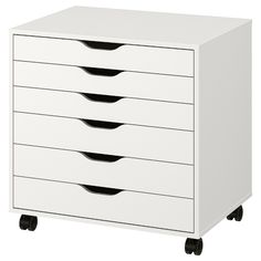 a white cabinet with five drawers and four black handles on casteors, against a white background