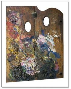 an old wooden door with two holes in the middle and paint splattered on it