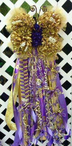 a purple and gold decoration hanging on a wall