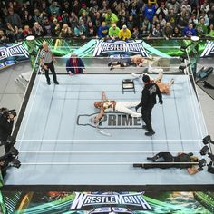 two men wrestling in an arena surrounded by people