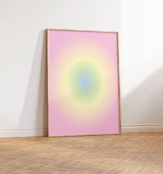 a pink and green painting on the wall in an empty room with hard wood flooring