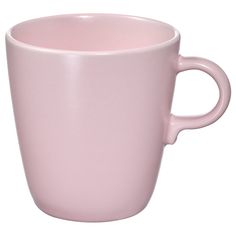 a pink coffee cup sitting on top of a white table