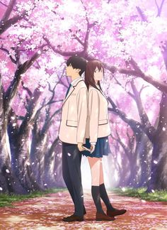 two people standing in front of trees with pink flowers