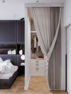 a bedroom with a bed, dresser and closet in the corner that has curtains on both sides