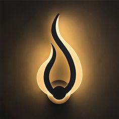 a light that is on the side of a wall with a black and white flame