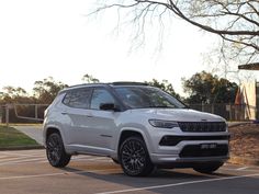 a white jeep parked in a parking lot