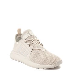 the adidas sneakers are white and have mesh detailing on the upper part of the shoe