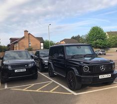 two black cars parked in a parking lot