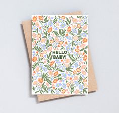 a card with the words hello baby written on it and colorful flowers all over it