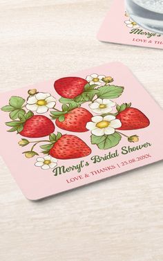 two coasters with strawberries and flowers on them