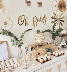 a baby shower party with cupcakes, cakes and decorations