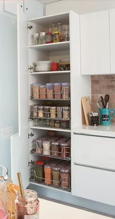 an organized pantry in a kitchen with lots of spices and condiments on the shelves