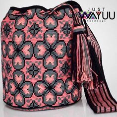 a pink and black bag with tassels on it