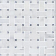 a white and grey tiled wall with squares