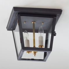 a light fixture with two candles on it