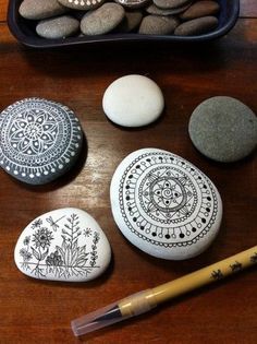 some rocks are sitting on a table next to a pencil