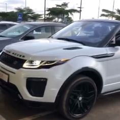 a white range rover parked in a parking lot