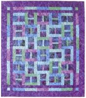 a purple and green quilt with squares on it