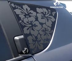 an image of a flower sticker on the side of a car that is parked