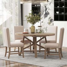 a dining room table with chairs and a vase