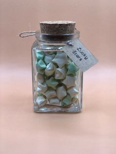 a glass jar filled with small white and green candies