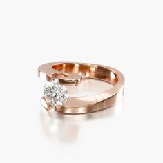 a rose gold ring with a single diamond