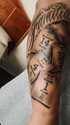 a man's arm with some tattoos on it