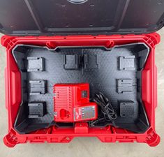 the inside of a red toolbox with tools in it