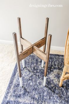 a chair sitting on top of a blue rug next to a wooden table with two legs