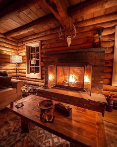 a living room with a fire place in the center and a couch next to it