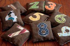 small brown pillows with numbers on them sitting on a wooden table next to each other