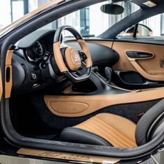 the interior of a car with tan leather and black trim