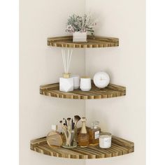 two wooden shelves with candles and other items on them