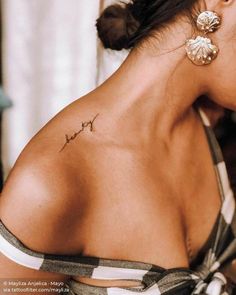 a woman with a small tattoo on her back