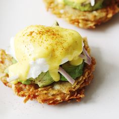 some food is sitting on a white plate and it looks like they are covered in mayonnaise