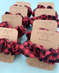 red and black plaid fabric scrunffles with name tags attached to the ends