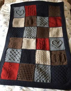 a crocheted blanket on top of a bed