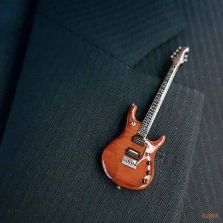 an electric guitar sitting on top of a suit jacket