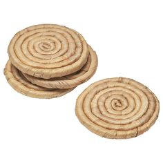 three wicker coasters with spiral designs on each side, set against a white background
