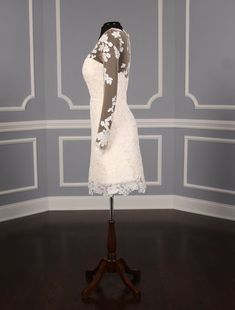 a mannequin dressed in a white lace dress