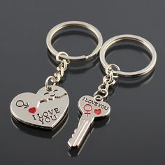 two heart shaped key chains with the words i love you written on them and one holding a pair of keys