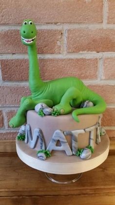 a birthday cake with a dinosaur on top