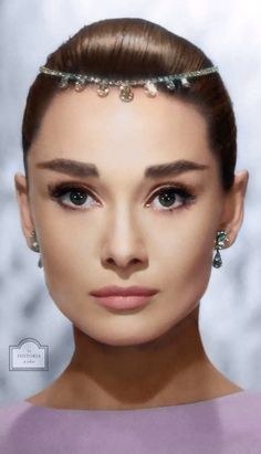 an image of a woman's face with pearls on her head and hair in a bun