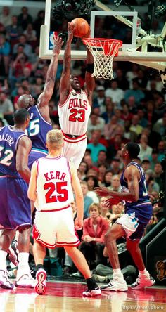 an image of a basketball game going on in the air with one player trying to block the ball