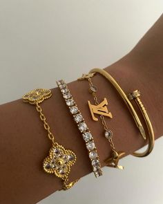 Elevate your style with our Gold Luxury Bracelets Set. Clover Crystals & Tennis Bracelet. Perfect for her. Shop now! Bracelet Stack Designer, Jewellery Aesthetic Bracelet, Gold Bracelet Sets, Gold Bracelet Stack Aesthetic, Gold Stack Bracelets, 2025 Goals, Dream Purse, Gold Bracelet Stack, Bracelets Aesthetic